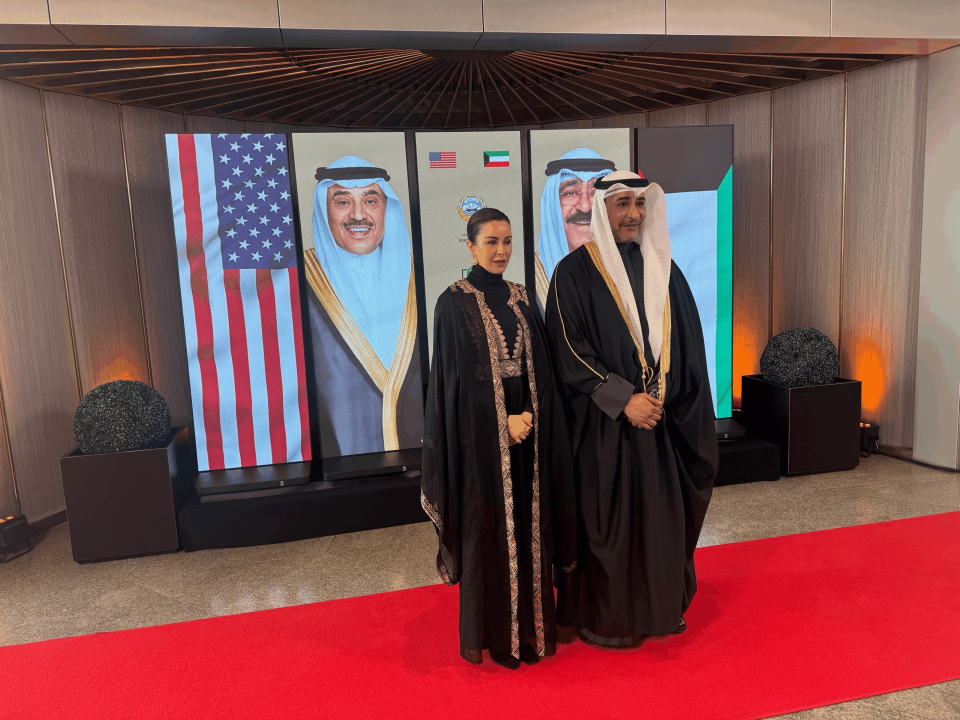 Guests photographed in front of the LED display wall at the Kuwait Embassy anniversary celebration in Washington, DC