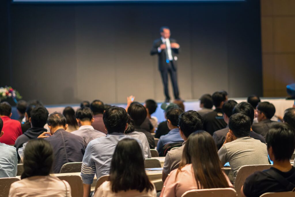Rear side of audiences sitting and listening the s