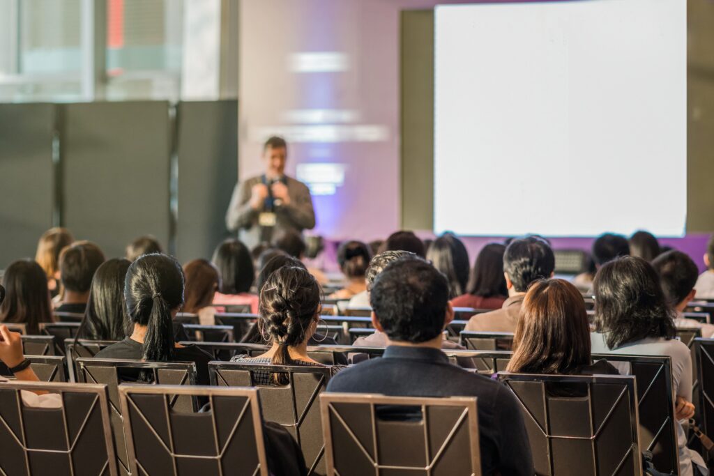 Rear view of audience in the conference hall or se