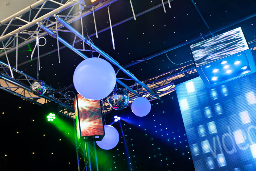 Wide angle view of spotlights and disco balls in a