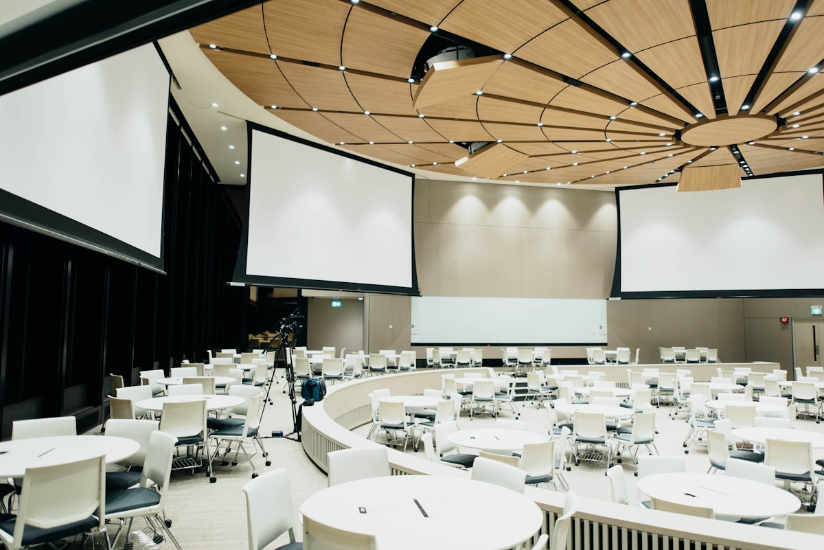 Breakout session room at a multi-day conference with professional AV setup and projection screens